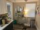 Small kitchen with white cabinets and a view into a bedroom at 1874 Douglas Ave, Clearwater, FL 33755
