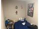 Small bedroom with a single bed and various personal items at 1874 Douglas Ave, Clearwater, FL 33755