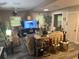 Spacious living room with a large TV, comfy sofa, and stylish decor at 1874 Douglas Ave, Clearwater, FL 33755