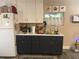 Small galley kitchen with dark cabinets and white countertops at 1874 Douglas Ave, Clearwater, FL 33755