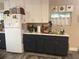 Bright kitchen with white cabinets, dark lower cabinets, and stainless steel appliances at 1874 Douglas Ave, Clearwater, FL 33755