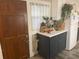 Small galley kitchen with dark lower cabinets and a unique countertop at 1874 Douglas Ave, Clearwater, FL 33755