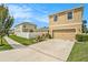 Two-story house with driveway, landscaping and a white fence at 3508 Diamond Leaf Ct, Valrico, FL 33594
