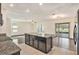 Open floor plan showcasing kitchen island and living room with wood-look floors at 3508 Diamond Leaf Ct, Valrico, FL 33594