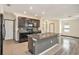 Kitchen island with granite countertop and dark wood cabinets at 3508 Diamond Leaf Ct, Valrico, FL 33594