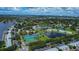 Aerial view of community with tennis courts, lush landscaping and waterfront access at 5144 Salmon Se Dr # A, St Petersburg, FL 33705