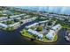 Aerial view of waterfront community with pool, tennis courts, and boat docks at 5144 Salmon Se Dr # A, St Petersburg, FL 33705
