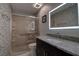 Updated bathroom with a walk-in shower and granite countertop at 5144 Salmon Se Dr # A, St Petersburg, FL 33705