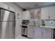 Modern kitchen with stainless steel appliances and light wood cabinets at 5144 Salmon Se Dr # A, St Petersburg, FL 33705