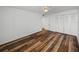 Well-lit bedroom with wood-look floors and double closets at 7100 Sunset Way # 405, St Pete Beach, FL 33706