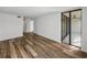 Living room with access to patio and wood-look floors at 7100 Sunset Way # 405, St Pete Beach, FL 33706