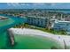 Aerial view of beachfront resort building and community at 7100 Sunset Way # 405, St Pete Beach, FL 33706