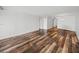 Bright living room with wood-look floors and access to balcony at 7100 Sunset Way # 405, St Pete Beach, FL 33706