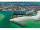 Aerial view of beachfront condo building with pool and beach access at 7100 Sunset Way # 405, St Pete Beach, FL 33706