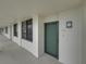 Hallway with access to condo unit, offering a welcoming entry point to the living space at 7100 Sunset Way # 405, St Pete Beach, FL 33706