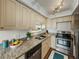 Well-lit kitchen showcasing granite countertops, stainless steel appliances, and classic cabinetry at 7100 Sunset Way # 405, St Pete Beach, FL 33706