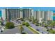 Aerial view of beachfront condo building with ample parking and convenient access to the beach at 7100 Sunset Way # 405, St Pete Beach, FL 33706