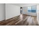 Bright living room featuring hardwood floors, large window with ocean views, and sliding door to balcony at 7100 Sunset Way # 405, St Pete Beach, FL 33706