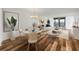 Open-concept living space with dining area, stylish furniture, hardwood floors, and waterfront views at 7100 Sunset Way # 405, St Pete Beach, FL 33706