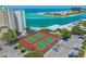 Two tennis courts near resort building and parking at 7100 Sunset Way # 405, St Pete Beach, FL 33706