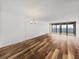 Bright living room with hardwood floors and sliding doors to balcony at 7100 Sunset Way # 405, St Pete Beach, FL 33706