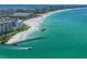 Aerial view showing beachfront property and boat in ocean at 7100 Sunset Way # 405, St Pete Beach, FL 33706