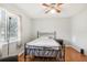 Simple bedroom with wood floors, ceiling fan and neutral color walls at 2507 Lancaster Dr, Sun City Center, FL 33573