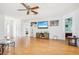 Living room with hardwood floors, flat-screen TV, and access to other rooms at 2507 Lancaster Dr, Sun City Center, FL 33573