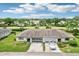 Aerial view of a two-unit home with a two-car garage and driveway at 2507 Lancaster Dr, Sun City Center, FL 33573