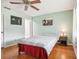 Light and airy bedroom with wood floors and ceiling fan at 2507 Lancaster Dr, Sun City Center, FL 33573