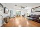 Spacious living room with hardwood floors and a view to the dining area at 2507 Lancaster Dr, Sun City Center, FL 33573