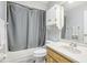 Simple bathroom with tub, shower, and wood vanity at 2507 Lancaster Dr, Sun City Center, FL 33573