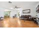 Spacious living room with hardwood floors and a comfortable leather couch at 2507 Lancaster Dr, Sun City Center, FL 33573