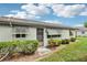 Well-maintained back exterior with lush landscaping and window awnings at 2507 Lancaster Dr, Sun City Center, FL 33573