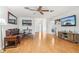 Bright living room featuring hardwood floors and a flat-screen TV at 2507 Lancaster Dr, Sun City Center, FL 33573