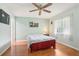 Cozy bedroom with wood floors, ceiling fan, and neutral decor at 2507 Lancaster Dr, Sun City Center, FL 33573