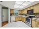 Bright kitchen features wood cabinets, tile floors, and modern appliances at 2507 Lancaster Dr, Sun City Center, FL 33573