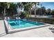 Relaxing community pool area with surrounding lush tropical foliage at 7037 Sunset S Dr # 602, South Pasadena, FL 33707