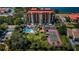 Aerial view showing condo building, pool, tennis court, and parking at 7037 Sunset S Dr # 602, South Pasadena, FL 33707
