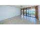 Living room with tile floors and sliding doors to balcony overlooking water at 7037 Sunset S Dr # 602, South Pasadena, FL 33707