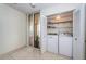 Laundry closet with washer, dryer, and additional storage shelving at 7037 Sunset S Dr # 602, South Pasadena, FL 33707