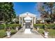 Landscaped garden entrance with classical features at 7037 Sunset S Dr # 602, South Pasadena, FL 33707