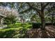 Lush lawn, mature trees, and manicured hedges at 7037 Sunset S Dr # 602, South Pasadena, FL 33707
