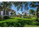 Landscaped lawn with building view, providing a tranquil setting at 7037 Sunset S Dr # 602, South Pasadena, FL 33707