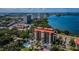 Aerial view of condo building, pool, tennis court, and waterfront location at 7037 Sunset S Dr # 602, South Pasadena, FL 33707