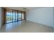 Bright living room with tiled floors and sliding glass doors leading to a balcony with water views at 7037 Sunset S Dr # 602, South Pasadena, FL 33707