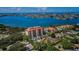 Aerial view of waterfront community with pool and tennis court at 7037 Sunset S Dr # 602, South Pasadena, FL 33707