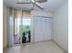 Bedroom with tile floors, a ceiling fan, and access to a balcony at 7037 Sunset S Dr # 602, South Pasadena, FL 33707
