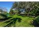 Expansive green lawn area with mature trees providing shade at 7037 Sunset S Dr # 602, South Pasadena, FL 33707