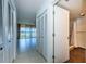 Hallway with tiled floors, closets, and view into living room and bathroom at 7037 Sunset S Dr # 602, South Pasadena, FL 33707